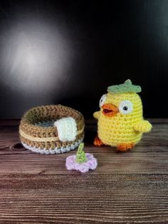 two small crocheted toys sitting on top of a wooden table