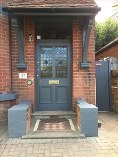 a blue front door on a brick house