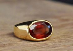 "Natural Certified Hessonite Garnet/Gomed 4.00 - 11.00 Ct. Gemstone Unisex Ring in Panchadhatu (Cooper),January Birthstone jewelry Ring Metal : Copper Stone : Natural Hessonite Garnet (Gomed) Size : 4 to 11 Ct. Shape : Oval Cutstone Gomed (Hessonite Garnet) is all the name of same stone which is the stone for Rahu. Gomed (Hessonite Garnet) is the gemstone for Rahu and by wearing Gomed (Hessonite Garnet) stone one gets relief from the atrocities of Rahu which it does on the native if it is not be Concave Gemstone Rings As Gift, January Birthstone Jewelry, Hessonite Garnet, January Birthstone, Garnet Stone, Unisex Ring, Evil Spirits, Ring Metal, Garnet Gemstone