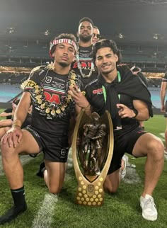 the rugby players are posing with their trophy