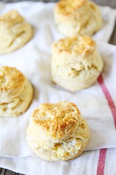 four biscuits on a white towel sitting on a table