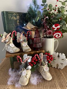 some christmas decorations are sitting on a table next to a potted plant and candy canes