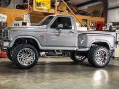 a silver truck parked inside of a garage