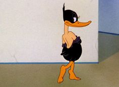 an animated duck is standing in front of a white wall and looking at the floor