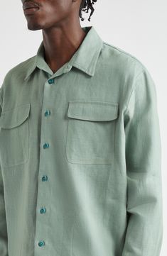 Inspired by a vintage workwear style found at the Saint-Ouen flea market in Paris, this relaxed-fit overshirt is crafted of linen that's been botanically dyed. 30" length; 48" chest (size 48 EU) Front button closure Spread collar Button cuffs Chest flap-patch pockets 100% linen Dry clean or hand wash, line dry Made in France Designer Clothing Vintage Relaxed Fit Button-up Shacket, Spring Linen Tops With Flap Pockets, Spring Linen Shirt With Patch Pockets, Spring Linen Tops With Patch Pockets, Long Sleeve Linen Top With Patch Pockets, Spring Shacket With Pockets And Spread Collar, Green Collared Tops With Welt Pockets, Green Button-up Shirt With Patch Pockets, Green Relaxed Fit Button-up Shacket