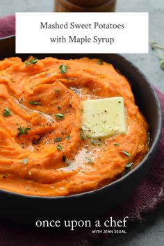 a bowl filled with mashed carrots and topped with a pate of butter