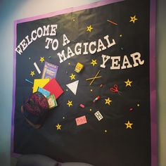 a welcome sign is hanging on the wall in front of a blackboard that says, welcome to a magical year