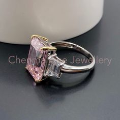 "This Morden LAVISH designer Pink Topaz ring is made with emerald cut pink Topaz with clear topaz side gemstones. The perfect Christmas gift for wife or for Mum. 💎 Main Gemstone: Pink Topaz 10*14mm 💎 Main Gemstone Shape: baguette 💎 Side Gemstones: Clear Topaz 💎 Material: Sterling Silver with rhodium finish. 💎 Band Size - please message us with your correct ring size. If you require any size that is not listed please send me a message. 『 Other Precious metal bands are available in 9k / 14k / Pink Radiant Cut Diamond Ring As Gift, Pink Radiant Cut Diamond Ring Gift, Pink Radiant Cut Diamond Ring For Anniversary, Radiant Cut Pink Diamond Ring As A Gift, Pink Rectangular Ring With Accent Stones, Modern Pink Diamond Rings, Luxury Rectangular Pink Rings, Luxury Pink Rectangular Rings, Pink Diamond Rings With Square Cut