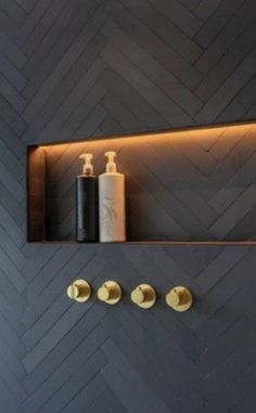 the bathroom is decorated in black and gold with modern fixtures, such as soap dispensers