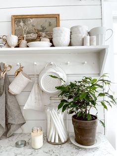 a kitchen counter with pots, pans and utensils hanging on the wall