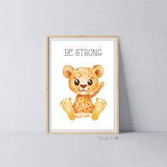 a framed poster with a cute little bear on it's face and the words be strong