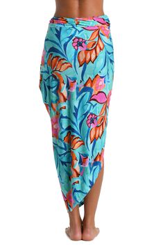 This pareo cover up features a vibrant and tropical floral print with a mix of teal, blue, pink, and orange hues, creating a lively and eye-catching pattern. The bold use of color and the large-scale floral motifs give the piece a fresh and summery feel. The sarong-style look with a faux wrap at the side offers a chic silhouette, looking equally beautiful resting around your hips over a swimsuit as it does paired with a cami. [split] Details Pareo cover-up Faux wrap Versatile style Fabric 95% Vi Hawaiian Multicolor Sarong With Tropical Print, Casual Multicolor Sarong For Beach Season, Multicolor Tropical Print Sarong For Vacation, Multicolor Tropical Print Sarong For Poolside, Multicolor Tropical Print Beachy Sarong, Beachy Multicolor Sarong With Tropical Print, Multicolor Tropical Sarong For Vacation, Tropical Multicolor Sarong For Poolside, Beachy Multicolor Tropical Print Sarong