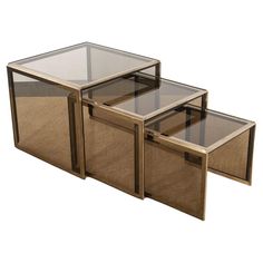 three tables with glass tops and wooden frames on each side, all in different sizes