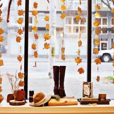 an instagram page with autumn leaves and boots on the table in front of a window