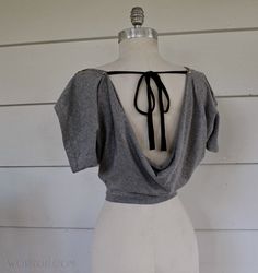 the back of a dress on a mannequin's dummy with black ribbon