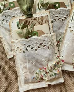 three pieces of cloth with flowers and leaves on them sitting on a table next to each other