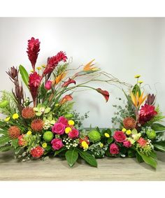 an arrangement of flowers arranged on a table