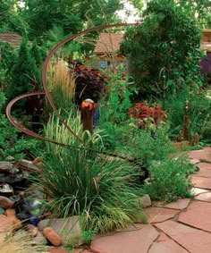 a garden with lots of plants and rocks