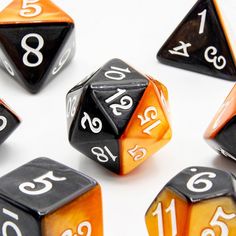 seven orange and black dice with numbers on them