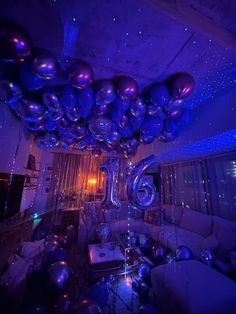 a living room filled with lots of shiny balloons