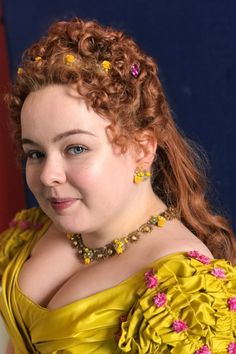 a woman with red hair wearing a yellow dress