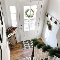 an overhead view of a white door with christmas wreaths on it