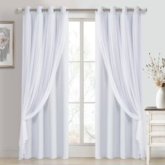 the curtains are open and ready to be hung in front of the window with white drapes