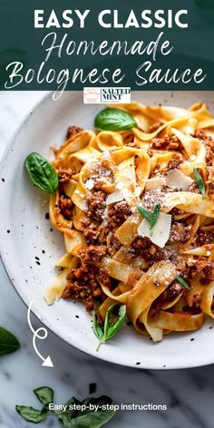 a white plate filled with pasta and sauce on top of a marble countertop text reads easy classic homemade bolognzoe sauce