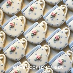 decorated cookies in the shape of teapots with pink roses and blue polka dots