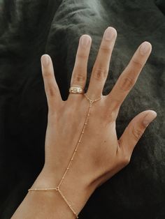 "This is a beautiful beaded hang chain in 14/20 gold-fill. Perfect for when you want something a little more special on your hand. It's great for laying and can be worn and never taken off. 14/20 Gold-fill reacts the same as 14k gold, in that it will never turn silver and if it gets dirty, a little cleaning will bring it back to its original shine! Measurements: The bracelet part of the piece is a little more than 7\", the chain up is 3.5\" and the chain around the finger is 2.5\". But if you ne