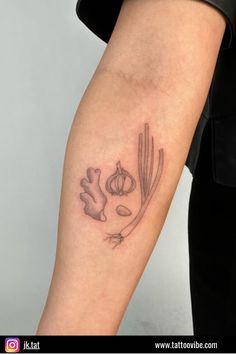 a woman's arm with a tattoo on it that has vegetables and meats