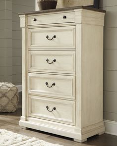 a white chest of drawers in a room