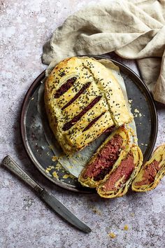 a meat loaf on a plate next to a knife