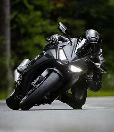 a man riding on the back of a black motorcycle