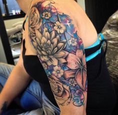 a woman with a flower tattoo on her arm