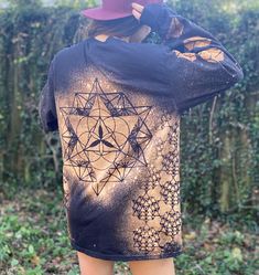 The design for this long sleeve shirt is based on the 64 point tetrahedron. Every image in the stencils used in this design can be created by connecting the major intersections of the grid laid out by this shape. The 64 point star tetrahedron in its three dimensional depiction is on the front of the shirt, overlaying its two dimensional version, the 64 Point Tetrahedron grid. Lining the sides of the shirt under the sleeves are three rows of three dimensional 64 Point Star Tetrahedrons. Down one Long Sleeve Tops With Star Print For Fall, Long Sleeve Star Print Tops For Fall, Long Sleeve Star Print Tops For Streetwear, Long Sleeve Tops With Star Print For Streetwear, Long Sleeve T-shirt With Sublimation Print, Long Sleeve Shirt With Sublimation Print, Long Sleeve Tops With Sublimation Print For Winter, Long Sleeve Shirt With Sublimation Print And Relaxed Fit, Long Sleeve Shirt With Sublimation Print, Relaxed Fit