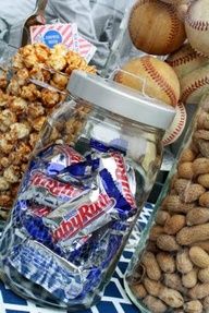 an assortment of nuts and snacks in glass containers on a blue and white table cloth