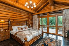 a large bed sitting inside of a bedroom next to a wooden wall and flooring