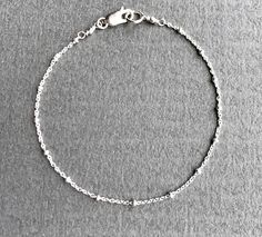 "Dainty Sterling Silver Chain Bracelet The perfect dainty chain to wear everyday! This satellite chain has such incredible shine and sparkle. Really pretty when layered with other bracelets and a terrific addition to any jewelry collection. ✦Also available in 14K gold fill - please see link below ✦For Satellite Necklace lengths - please see link below DESCRIPTION * Sterling Silver Satellite Chain, Lobster/trigger Clasp and Components * This is a delicate cable chain with accent beads of approxim Dainty Adjustable Silver Chain Bracelet, Dainty Silver Chain Bracelet, Silver Dainty Chain Link Bracelet, Minimalist Chain Bracelet With Round Beads And Adjustable Chain, Dainty Chain Bracelet With Adjustable Round Beads, Minimalist Adjustable Chain Bracelet With Round Beads, Dainty Nickel-free Chain Bracelet For Everyday, Dainty Hypoallergenic Chain Bracelet With Round Beads, Adjustable Satellite Chain Bracelet