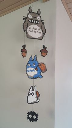 the crocheted mobile is hanging from the ceiling in front of a wall with cartoon characters on it