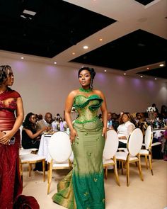 two women in dresses standing next to each other