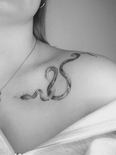 a woman with a snake tattoo on her chest