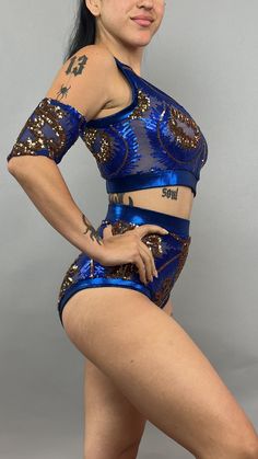 a woman in blue and gold outfit posing