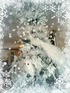 a christmas tree decorated with white snowflakes and polar bear figurines is shown