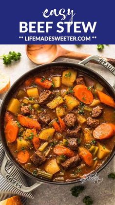 beef stew with carrots, potatoes and parsley in a pot on a table