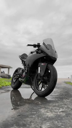 the motorcycle is parked on the wet road