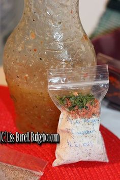 a bag of spices sitting on top of a table next to a bottle filled with seasoning