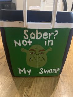 a green and white cooler bag with the words sobber? not in my swamp on it