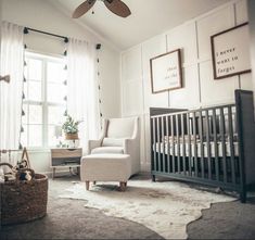 a baby's room with a crib, rocking chair and window in it