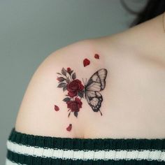 a woman with a butterfly and roses tattoo on her shoulder